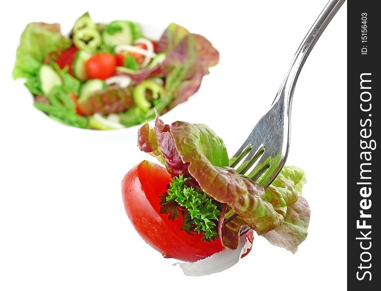 Silver fork with vegetable salad