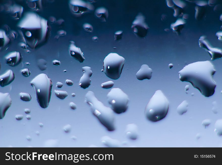 Macro of Blue Water Drops on Glass