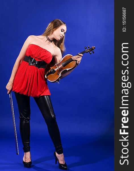 A young brunette woman holding her violin. A young brunette woman holding her violin