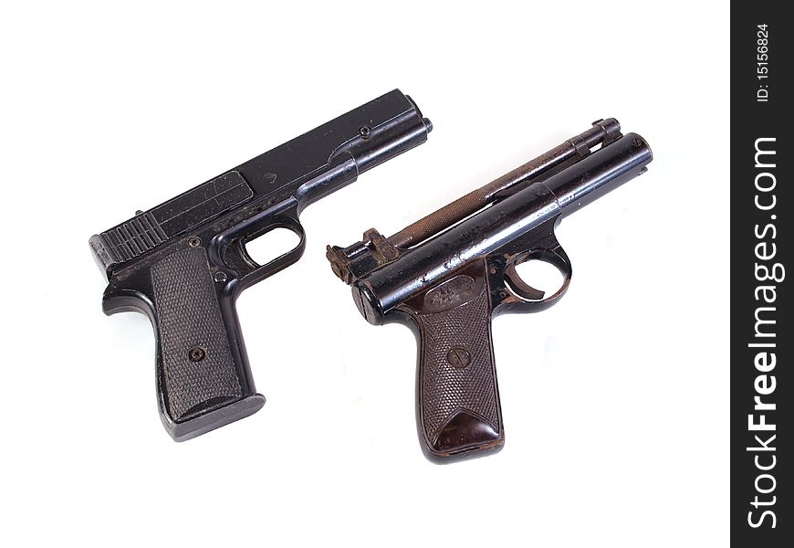 Old hand guns on a plain white background.