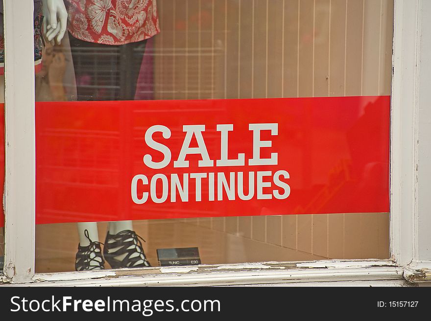 An image of a sign ' sale continues'  in a shop window showing that retail sales require continuing stimulus in the recession. An image of a sign ' sale continues'  in a shop window showing that retail sales require continuing stimulus in the recession.