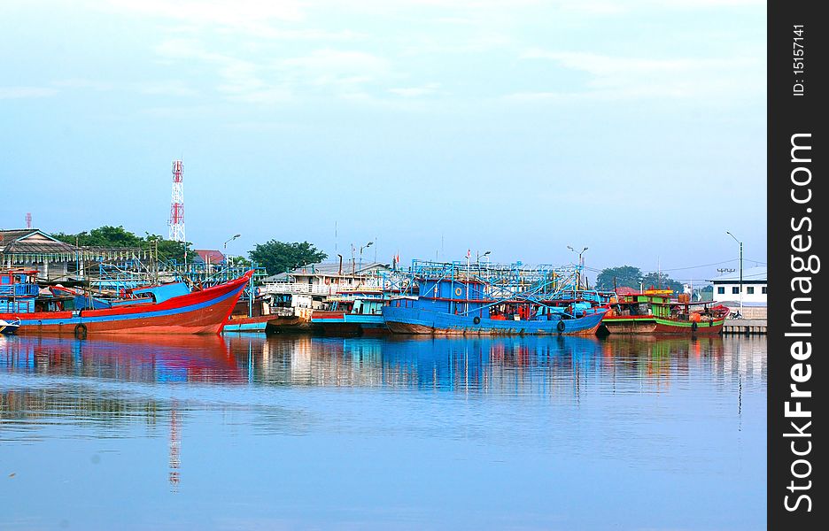 A scenery of a dock side, with many wooden boat on docks