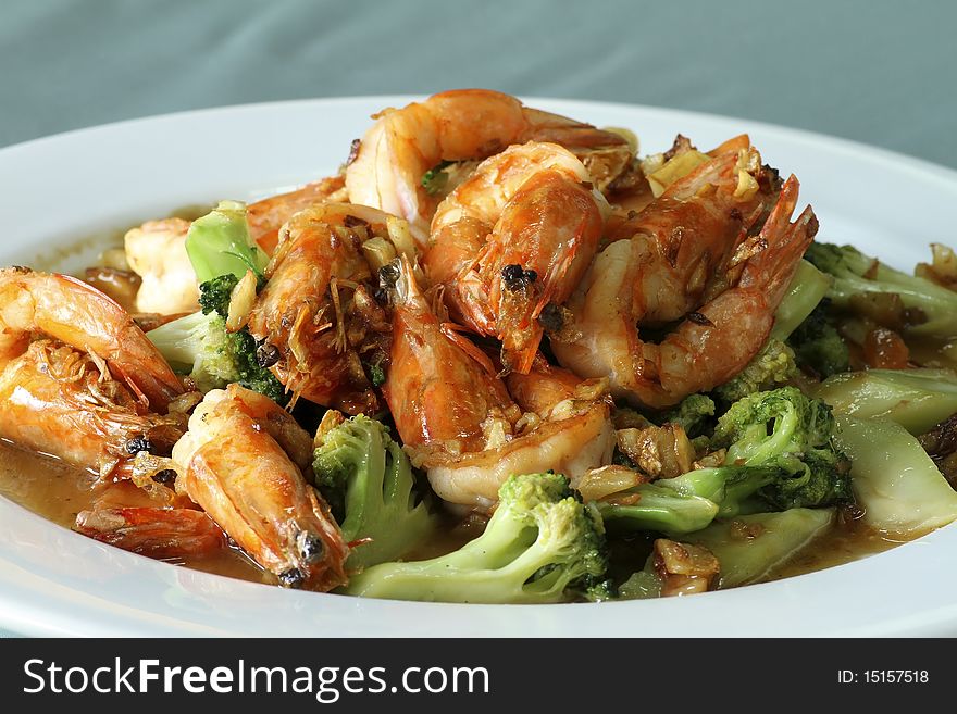 Fried shrimp placed on a white plate.