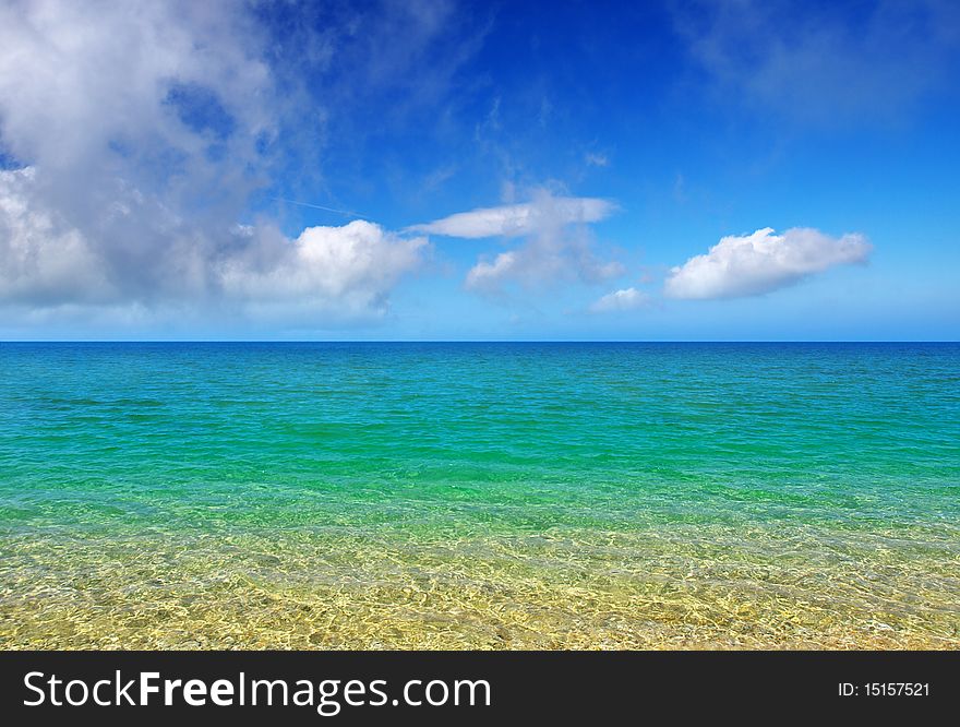 Turquoise sea and blue bright sky with cloud.