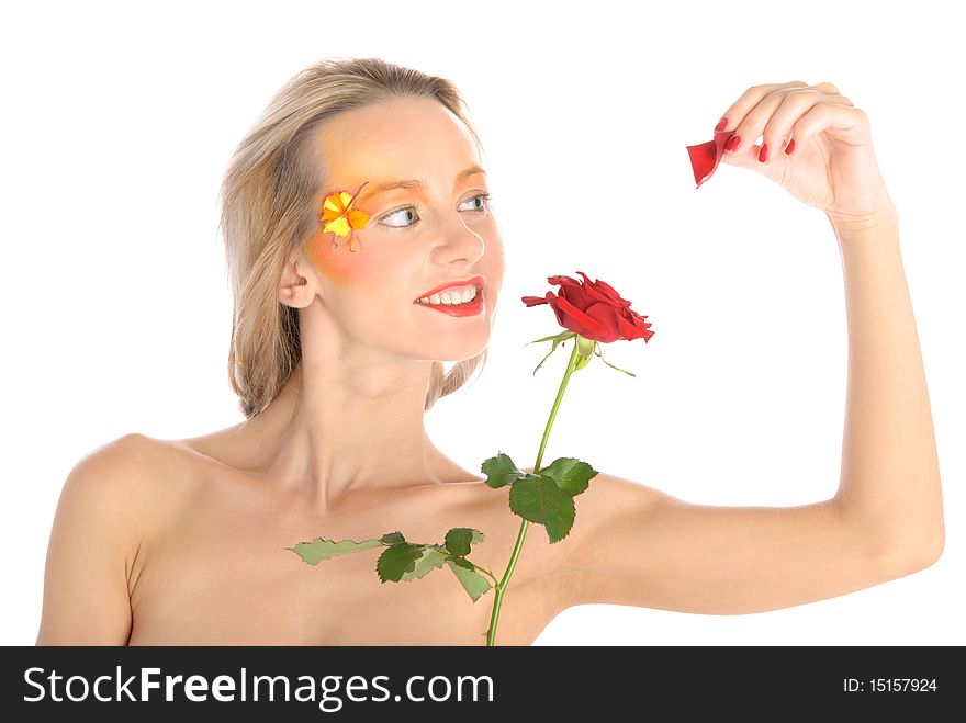 Young woman tears off petals at flower isolated in white