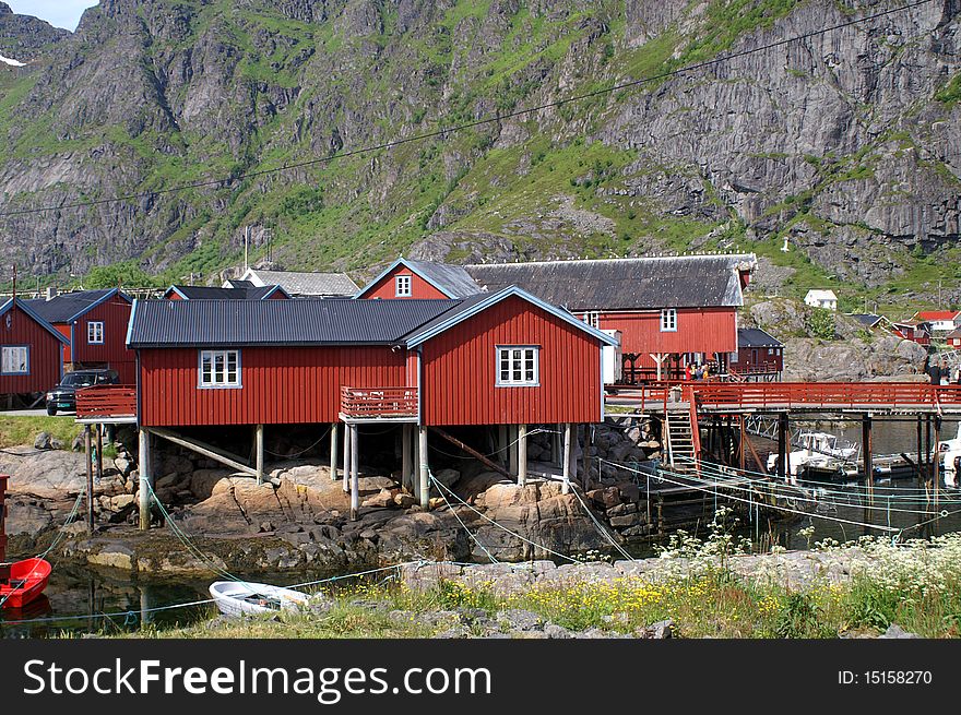 Fisherman's cabins and boats in a fjord at Lofoten islands, Norway. Fisherman's cabins and boats in a fjord at Lofoten islands, Norway