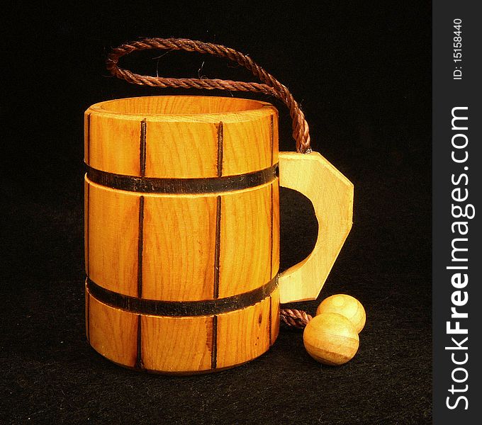 Mug of the juniper tree with a ball and rope on black velvet. Mug of the juniper tree with a ball and rope on black velvet.