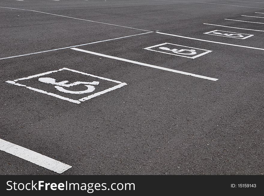 Wheel chair symbol with asphalt road