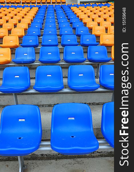 Blue and orange color seat in football stadium