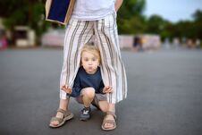 Little Playful Boy Having Fun During Walking With His Mother. Child Fooling Around Warm Summer Evening In Public Park Royalty Free Stock Photos