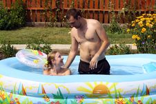 Pair Bathes In Inflatable Pool Royalty Free Stock Image