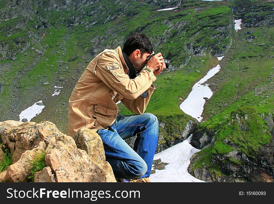 Photographer taking shots in the mountains