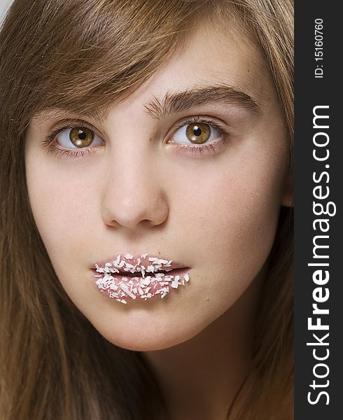 Young beautiful girl with a coconut shaving on lips
