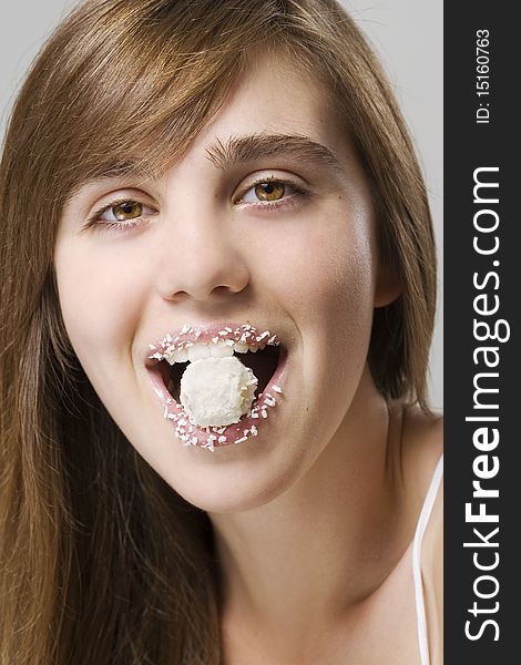 Woman biting white candy