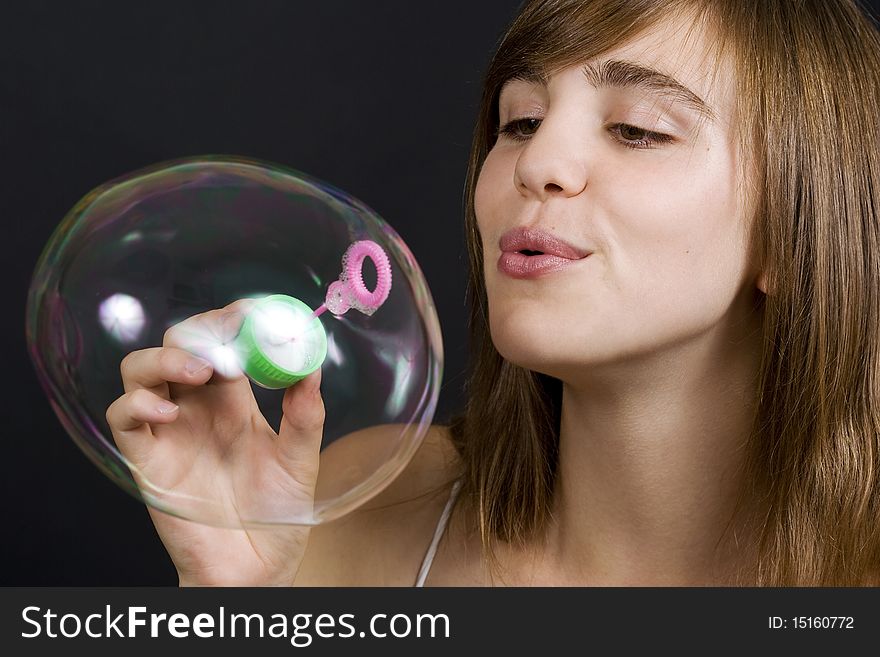 Young woman playing with bubbles. Young woman playing with bubbles