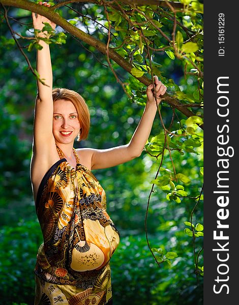 Attractive young woman holding branch og apple-tree. Attractive young woman holding branch og apple-tree