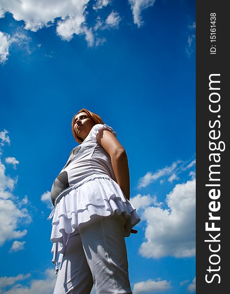 Pregnant Woman On Cloudy Blue Sky Background