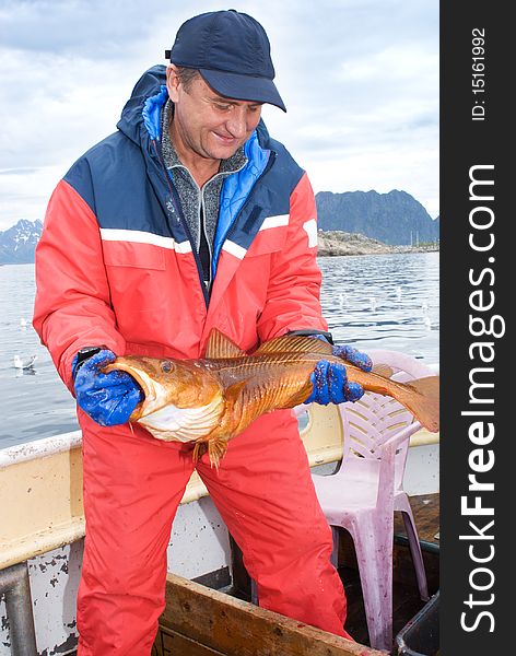 Fisherman with big fish on the boat