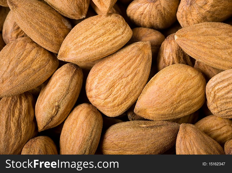 Background of almonds, close up studio shot. Background of almonds, close up studio shot.