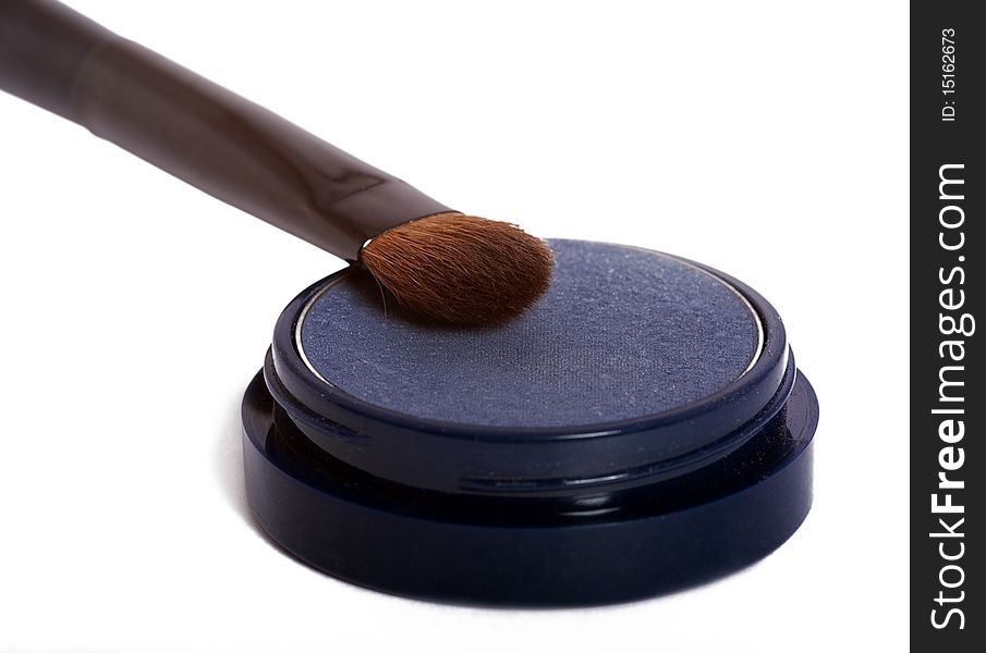 Blue eyeshadow and brush isolated on white