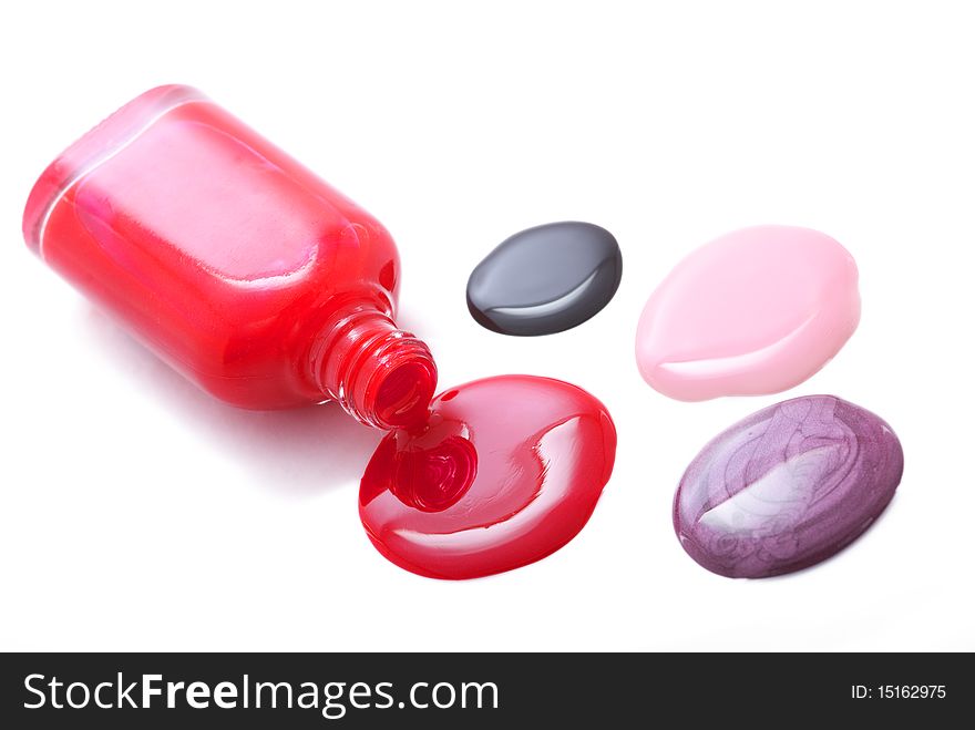 Spilled nail polish of many colors isolated on white