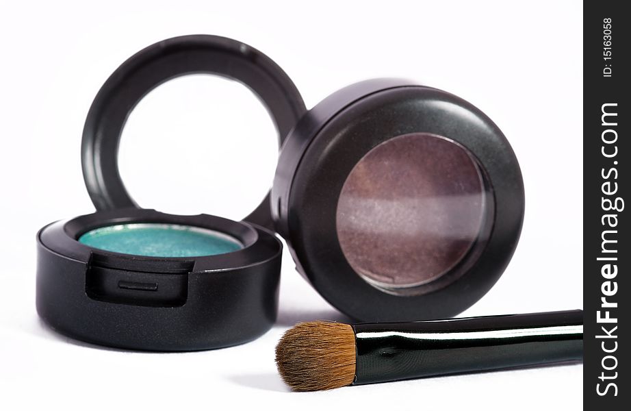 Two eyeshadows and cosmetic brush isolated on white. Two eyeshadows and cosmetic brush isolated on white