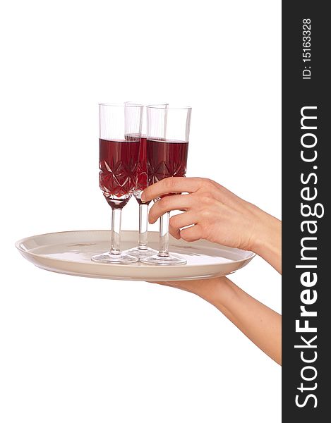 A waiter takes a glass of champagne from a tray with three glasses. A waiter takes a glass of champagne from a tray with three glasses