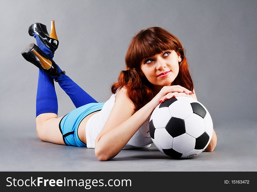Lying young girl on floor with a soccer ball. Lying young girl on floor with a soccer ball