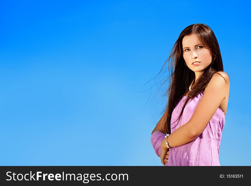 Happy young model on sky background.