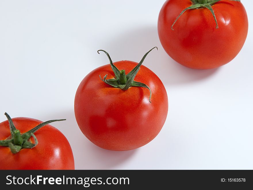 Close up of 3 tomatoes in a white background. Close up of 3 tomatoes in a white background