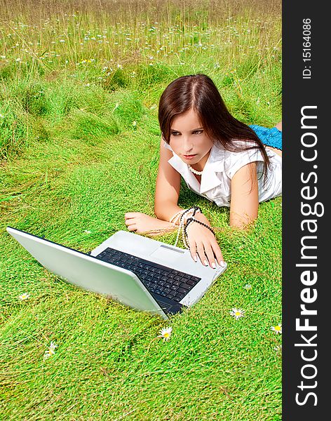 Beauty And Laptop On A Grass.