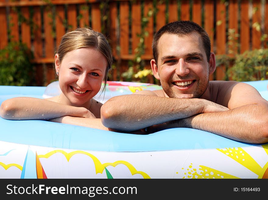 Young pair bathes in inflatable pool