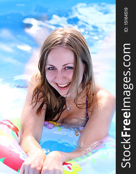 Portrait of a beautiful happy woman in swimming pool