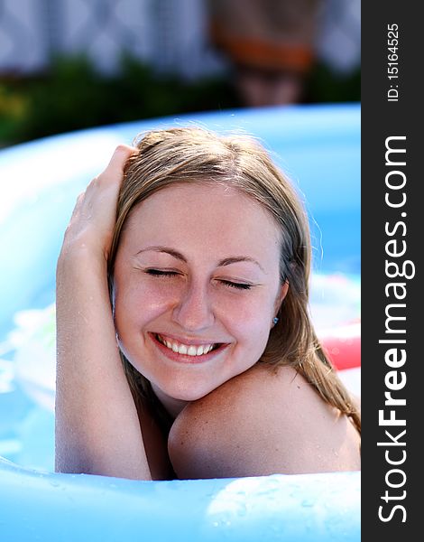 Portrait of a beautiful happy woman in swimming pool