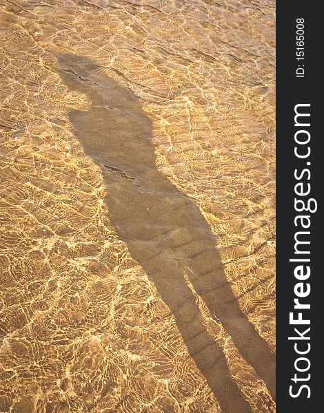 Shadow of a slender young girl in the water. Shadow of a slender young girl in the water