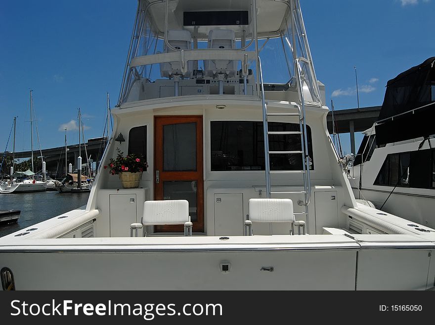 Aft cockpit of sport fishing boat docked at marina.