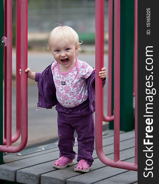 Portrait of the beautiful baby girl on playground