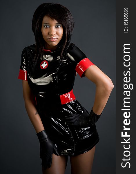 Young black woman in rubber costume and rubber gloves. Young black woman in rubber costume and rubber gloves