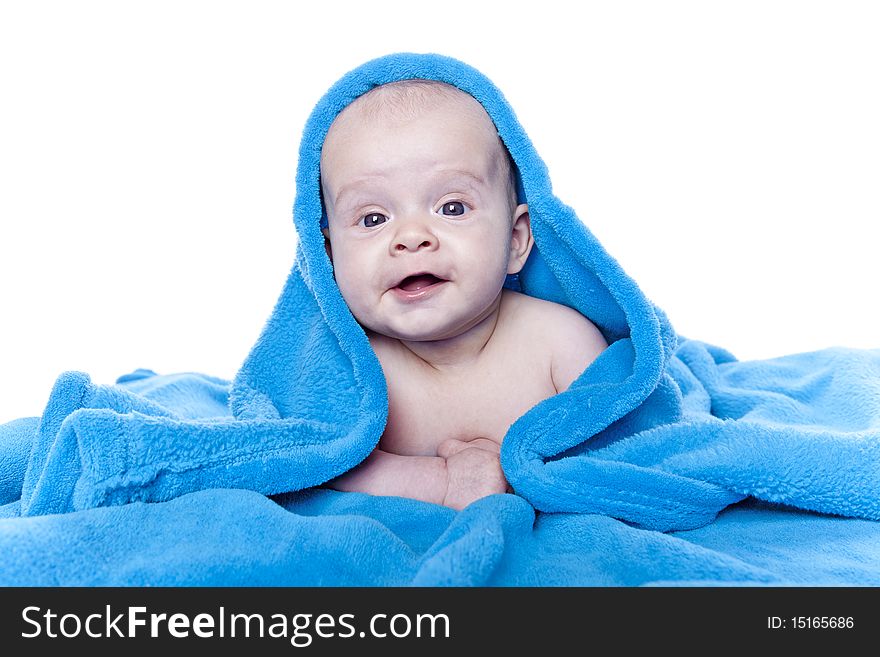 Beautiful baby under a blue towel on white background