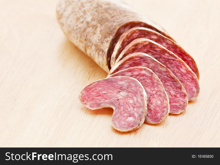 Sausage and slices on breadboard. Sausage and slices on breadboard