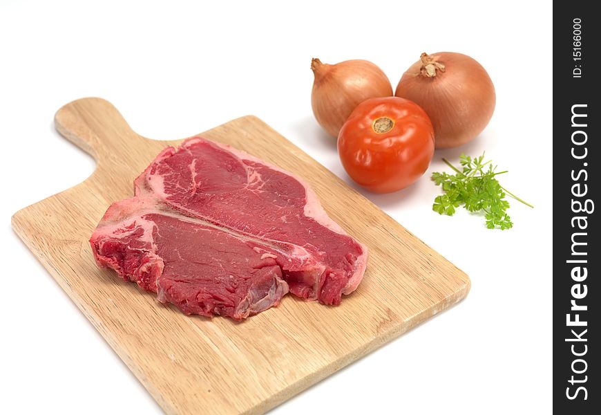 A T Bone steak isolated against a white background. A T Bone steak isolated against a white background