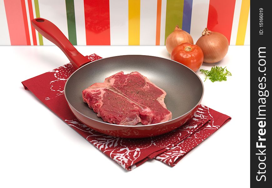 A raw T Bone steak on a kitchen bench