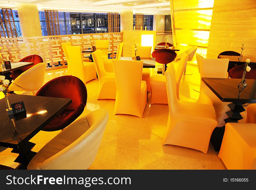 Luxury hotel cafeteria,sofas and wood table with soft yellow lighting. Luxury hotel cafeteria,sofas and wood table with soft yellow lighting.