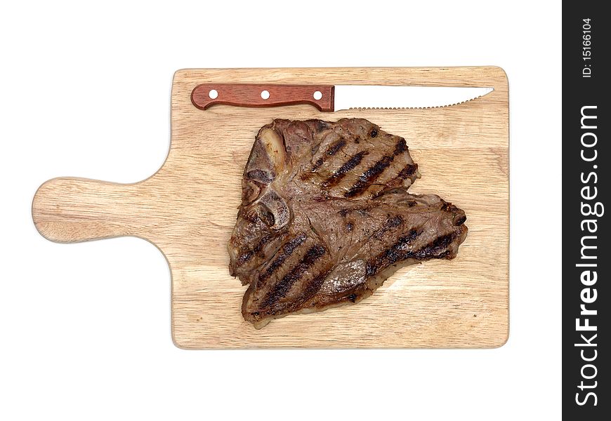A T Bone steak on a cutting board isolated against a white background