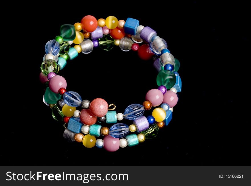 Multi colored round highlight beads strung as wired loop bracelet. Multi colored round highlight beads strung as wired loop bracelet