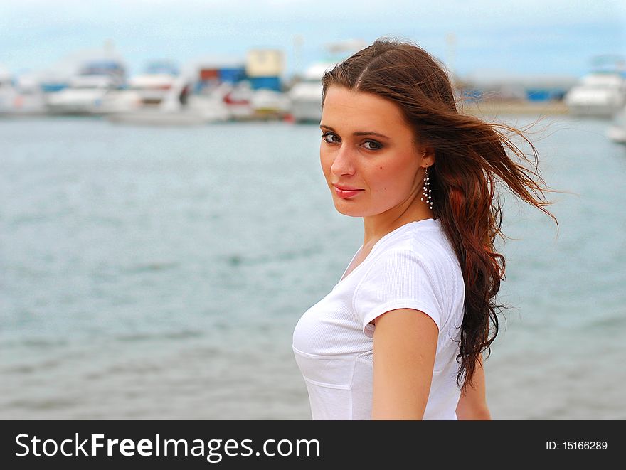 Young beautiful woman near the windy sea with free copy place. Young beautiful woman near the windy sea with free copy place