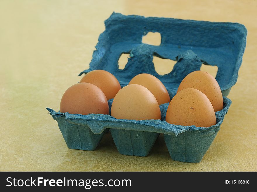 Six eggs in a blue container
