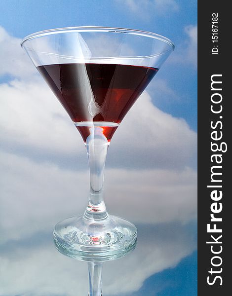 Red wine in glass on a background sky