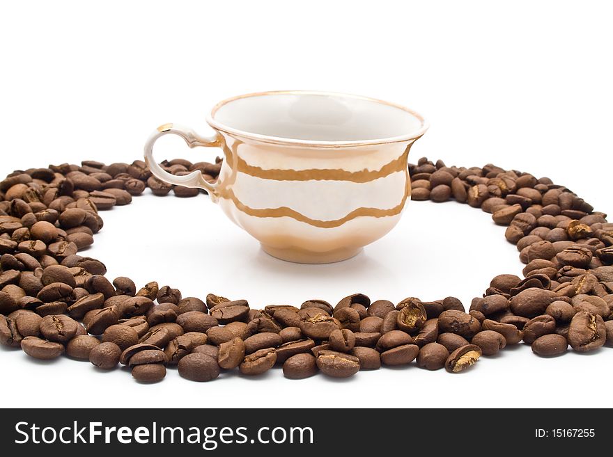 Grains of coffee and cup on a white background