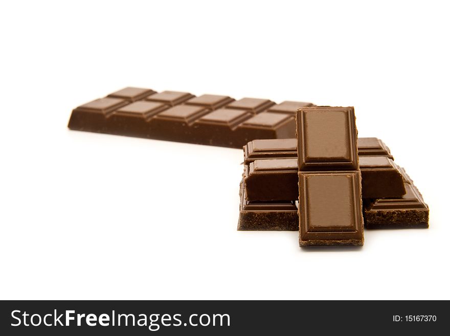 Stick of black chocolate on a white background